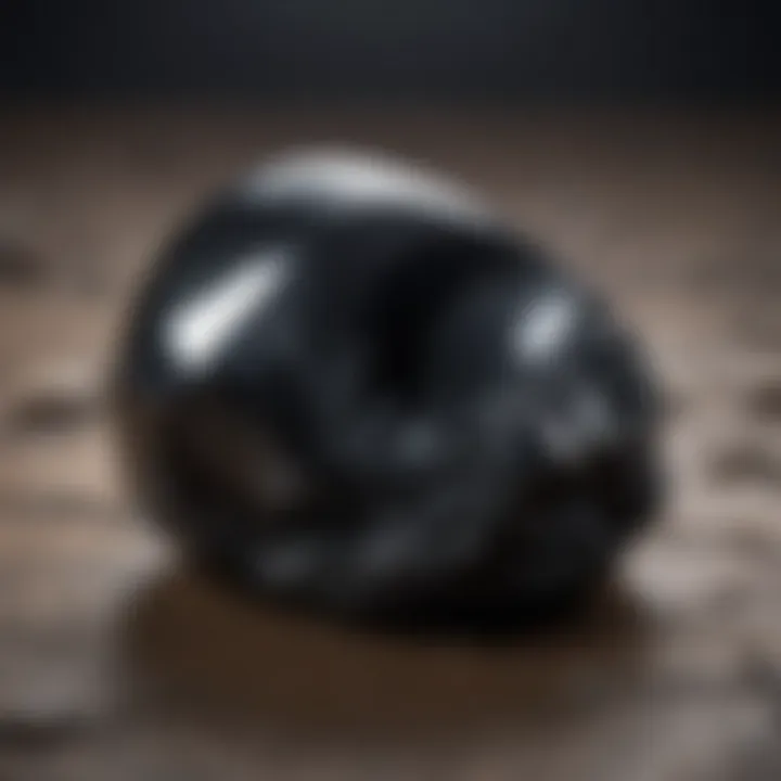 A close-up of a polished obsidian stone showcasing its glassy luster