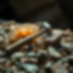 A small rock hammer resting on a bed of assorted geological specimens