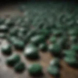 Various dark green stones displayed on a rustic surface