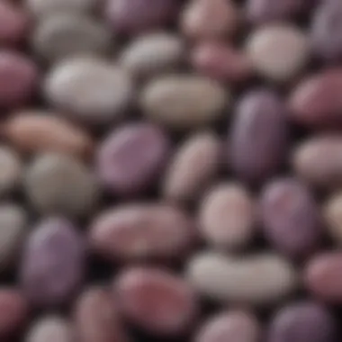 Close-up of polished lepidolite palm stones arranged aesthetically.