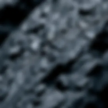 Close-Up of Smooth Black Rock Texture A close-up view of smooth black rock showcasing its shiny surface and unique texture.